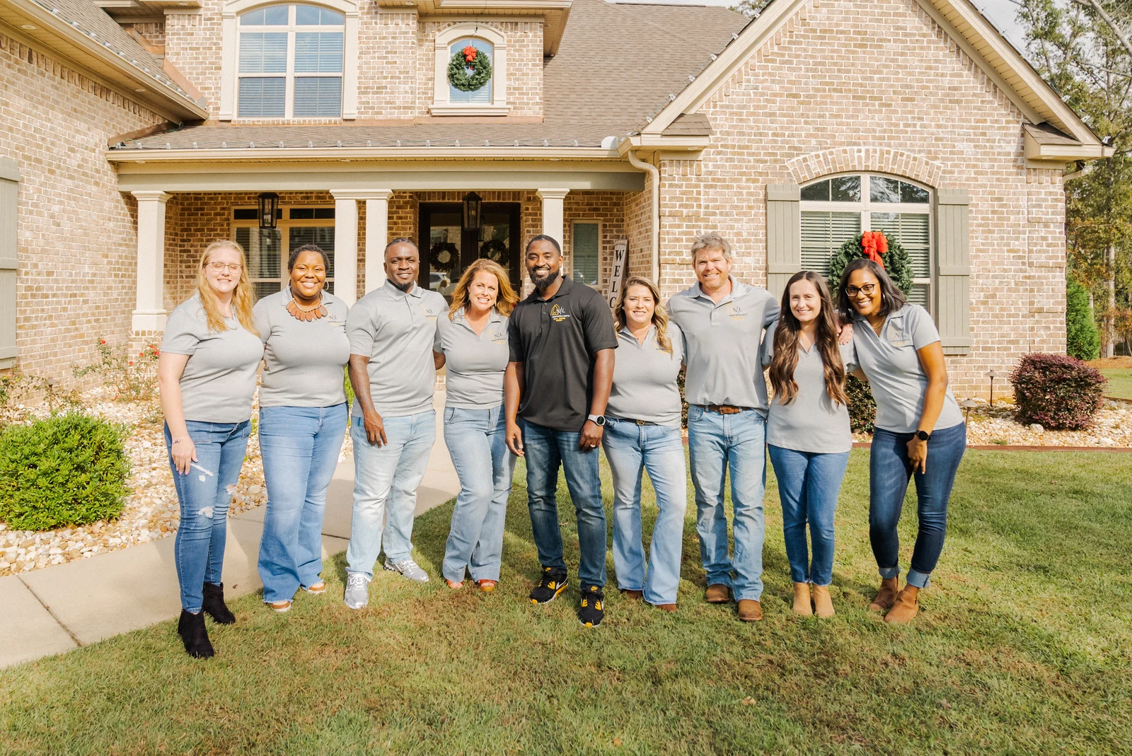 The Northern Lights Real Estate team together outside a home