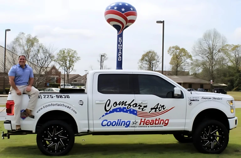 Bernie Joerger of Comfort Air beside a company truck